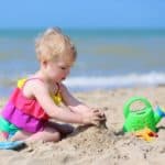 child on beach making sandcastle who might learn about failure